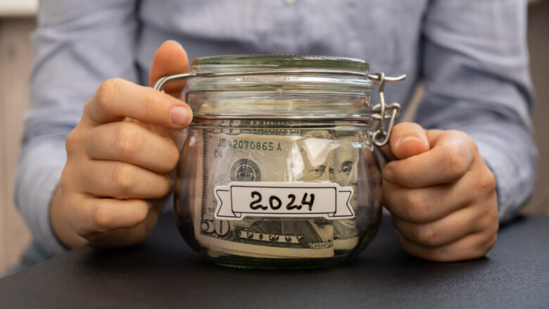 woman's hands holding jar of money