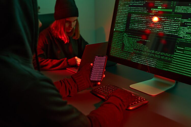 Anonymous people using computer and programming to break code. Cyber security threat. Internet and network security. Access to private information. Anonymous hackers using technology to access to password and encrypted data. Cyber attack