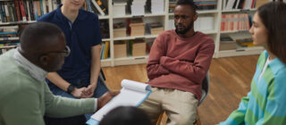 therapy session with young college students sitting in circle