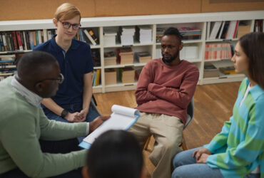 therapy session with young college students sitting in circle