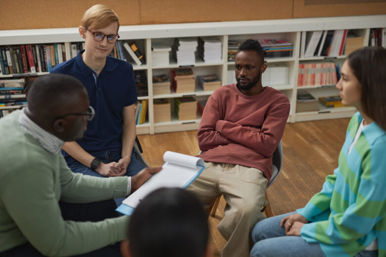 therapy session with young college students sitting in circle