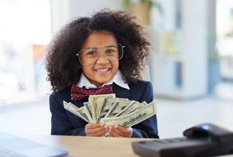 Little girl holding handful of cash