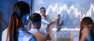 people gathered around stock charts