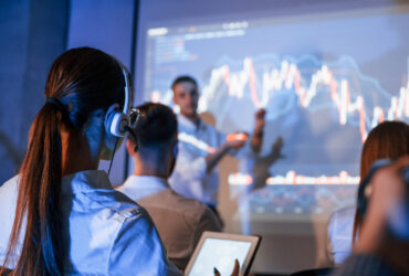 people gathered around stock charts