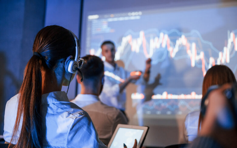 people gathered around stock charts